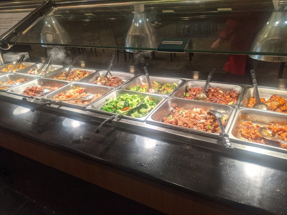 Rows of hot dishes in an Asian buffet